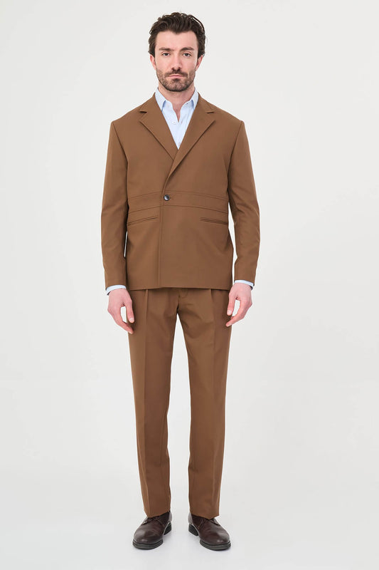 Man wearing a camel slim-fit two-piece suit, tailored for summer, standing outdoors, front view.