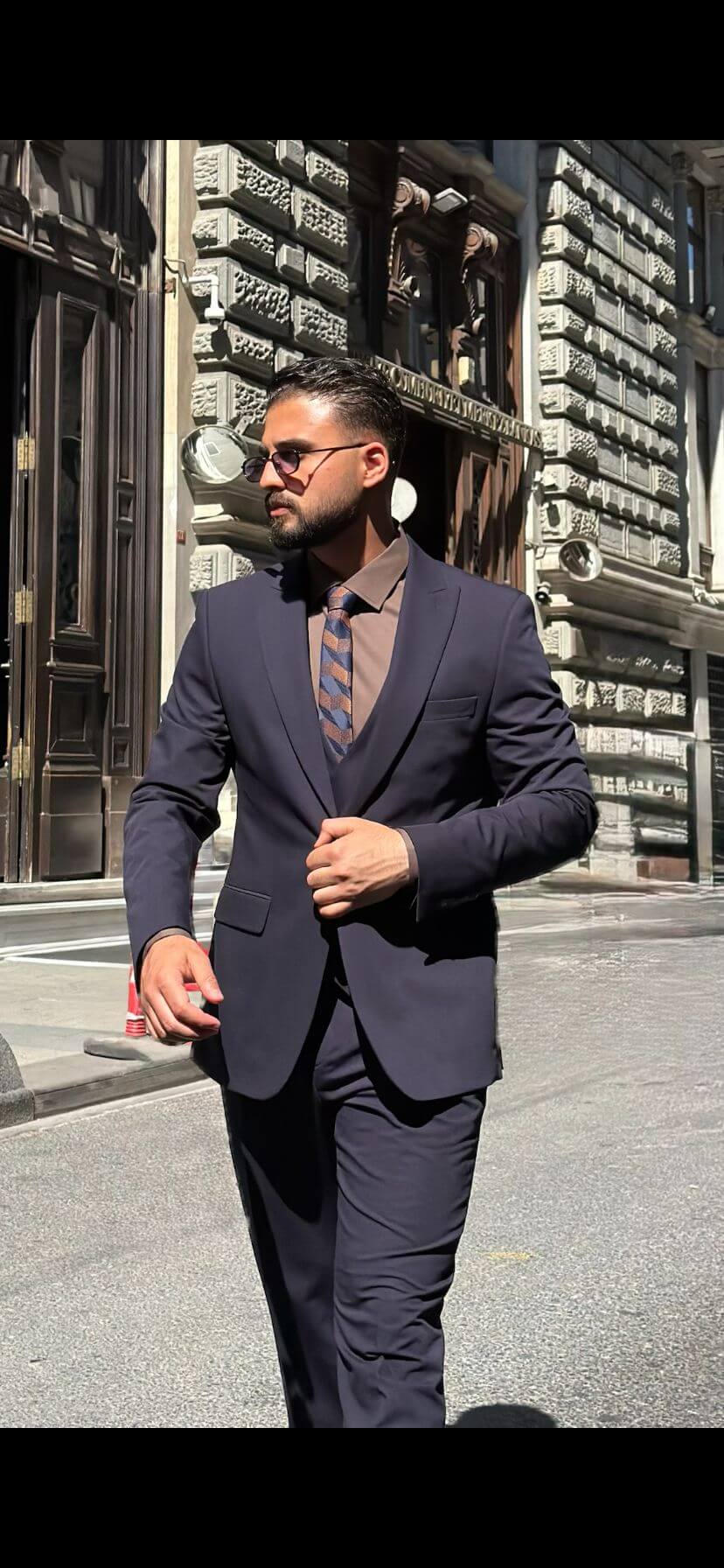 Men’s navy blue three piece suit with tailored jacket, matching waistcoat, trousers, and elegant formal design for weddings, business, and special occasions.