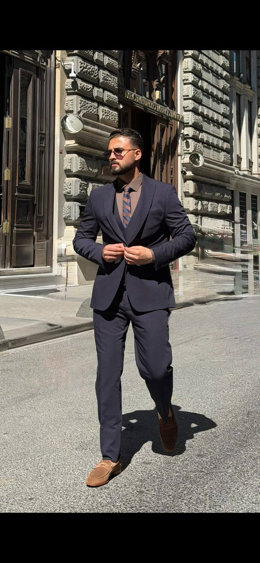 Men’s navy blue three piece suit with tailored jacket, matching waistcoat, trousers, and elegant formal design for weddings, business, and special occasions.