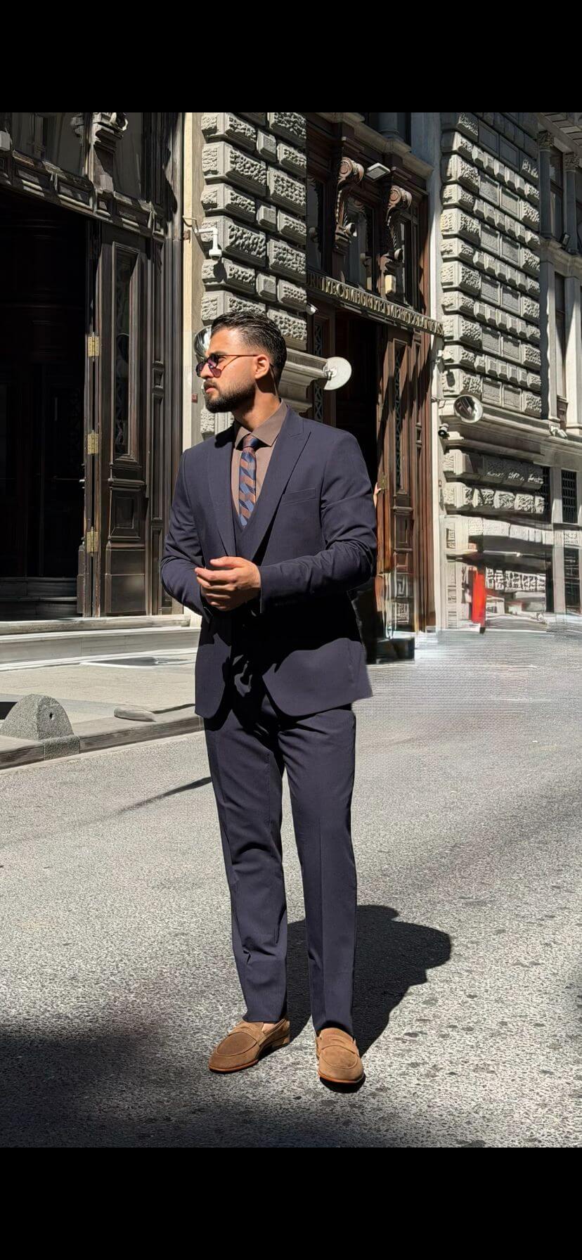 Men’s navy blue three piece suit with tailored jacket, matching waistcoat, trousers, and elegant formal design for weddings, business, and special occasions.