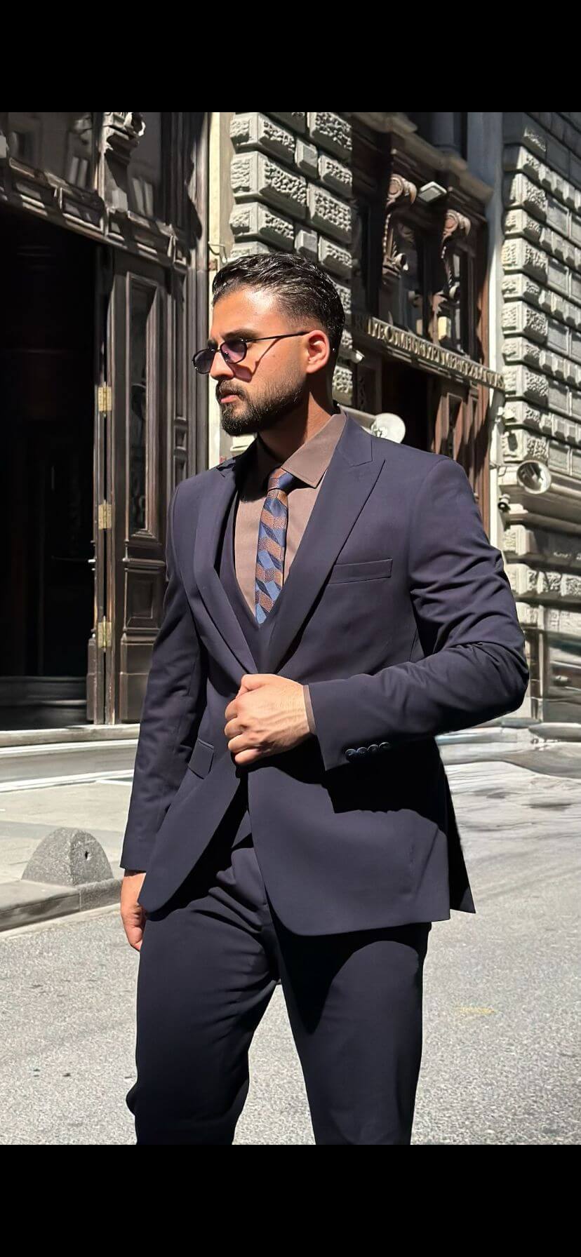 Men’s navy blue three piece suit with tailored jacket, matching waistcoat, trousers, and elegant formal design for weddings, business, and special occasions.