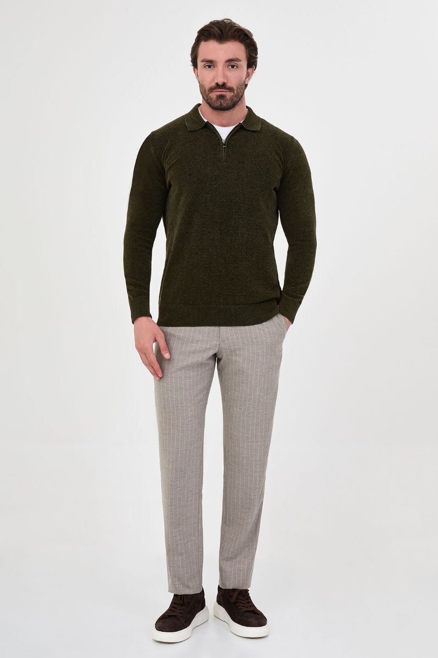 Men’s khaki polo neck knit sweater with zip collar detail styled with grey trousers for a refined fall winter smart-casual outfit.