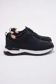 Midnight blue leather trainer sneaker with athletic silhouette, side view