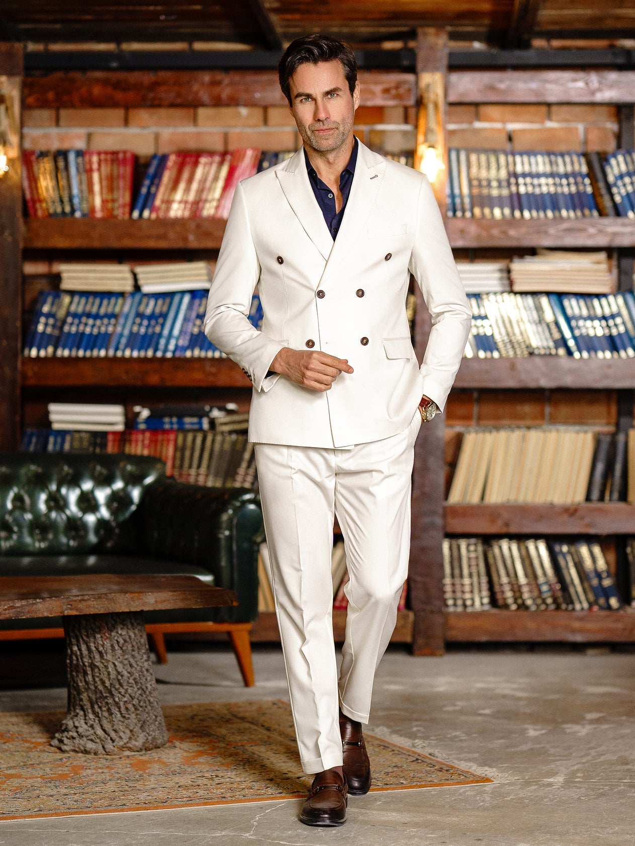 Men’s white double-breasted slim-fit suit with tailored trousers, styled with a dress shirt and tie for a clean, modern formal look.