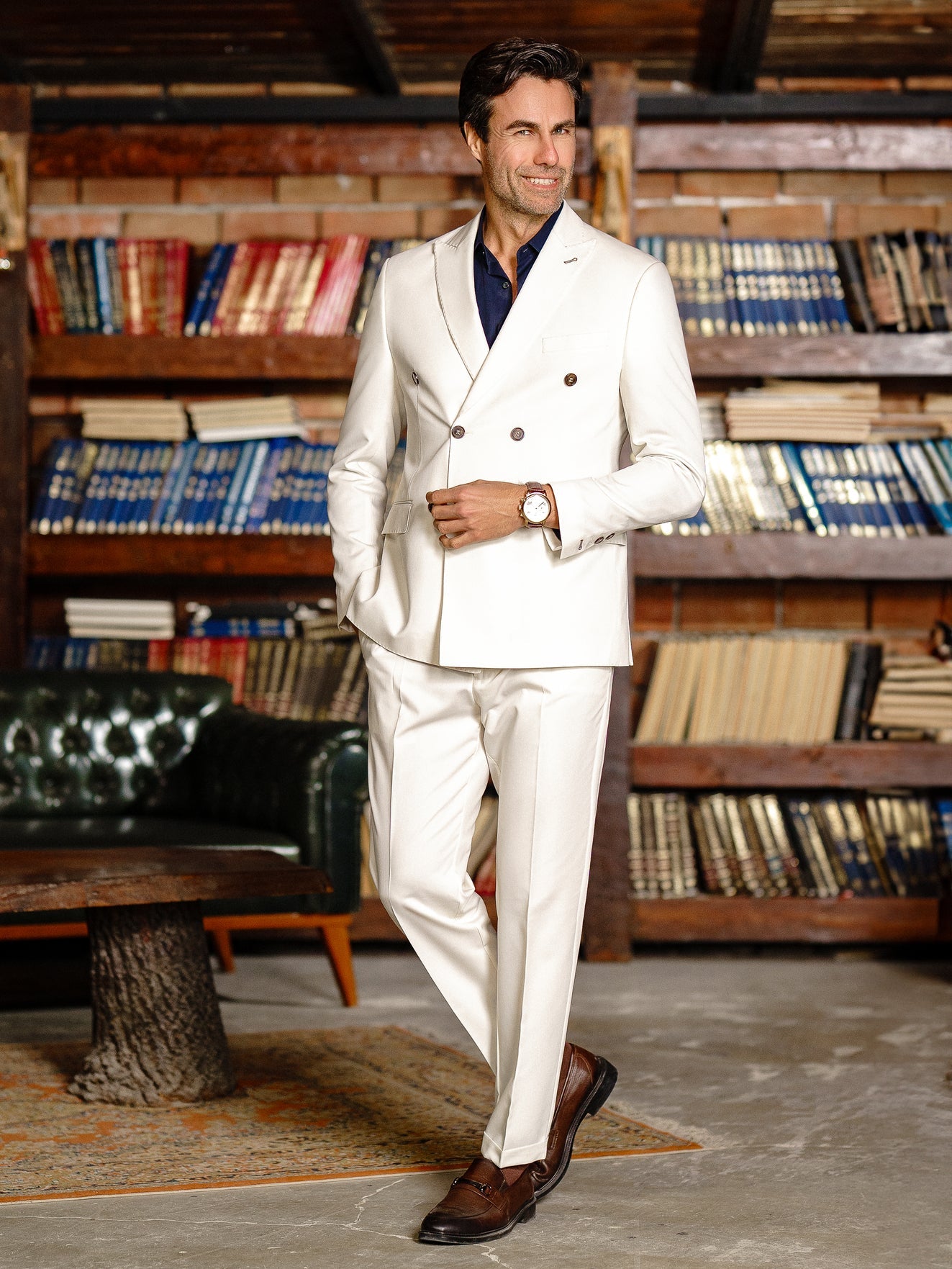 Men’s white double-breasted slim-fit suit with tailored trousers, styled with a dress shirt and tie for a clean, modern formal look.
