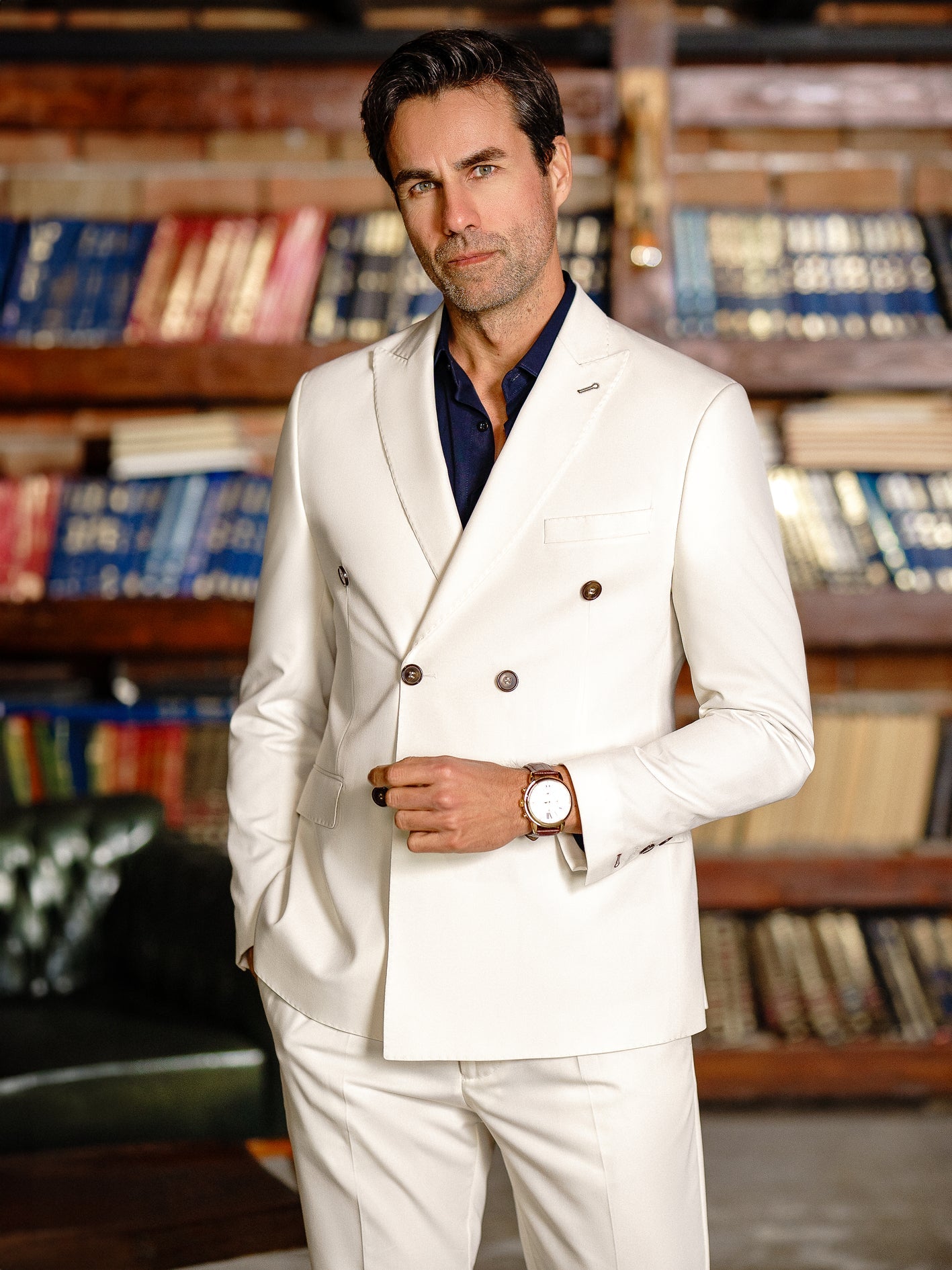 Men’s white double-breasted slim-fit suit with tailored trousers, styled with a dress shirt and tie for a clean, modern formal look.