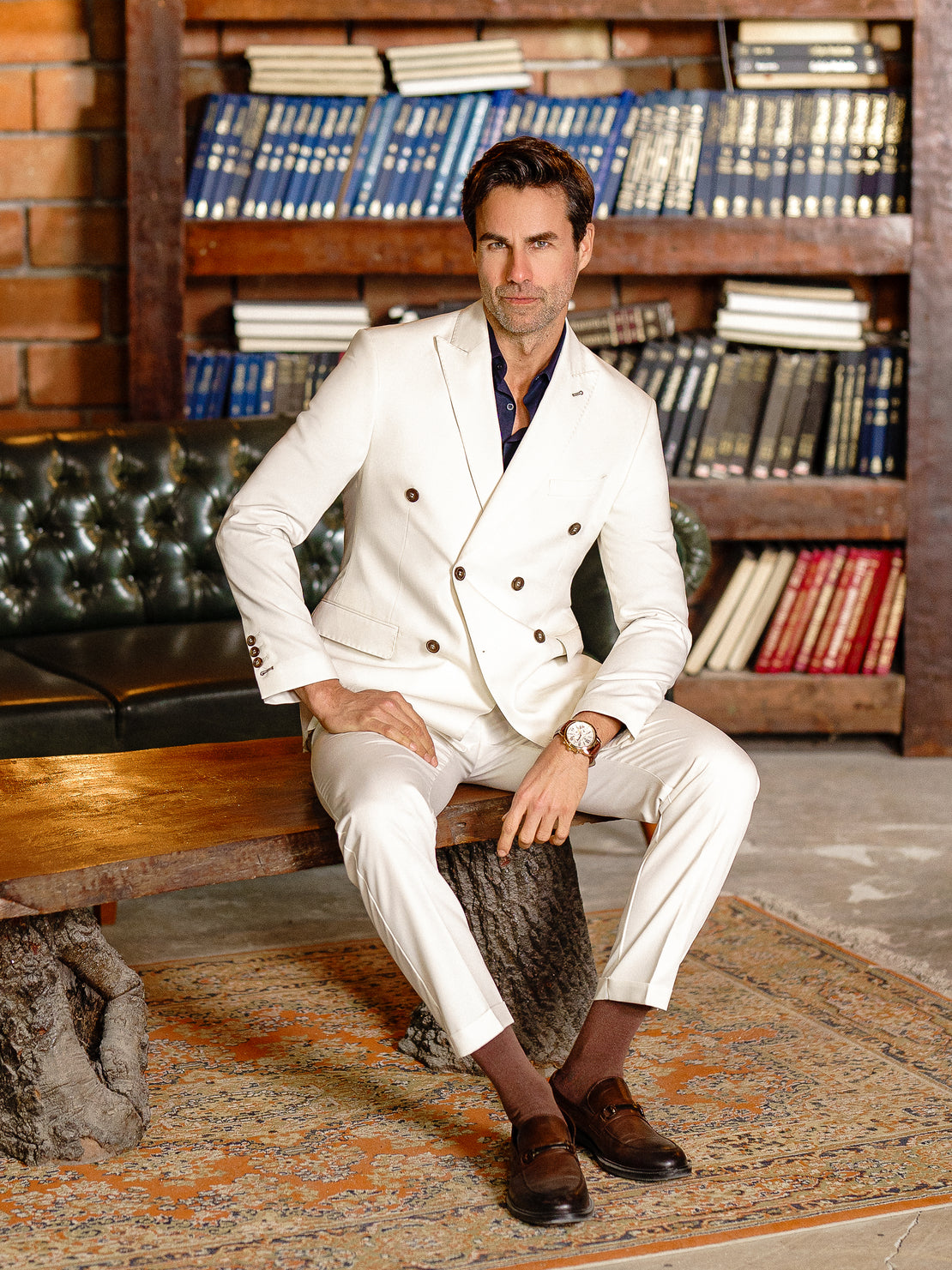 Men’s white double-breasted slim-fit suit with tailored trousers, styled with a dress shirt and tie for a clean, modern formal look.