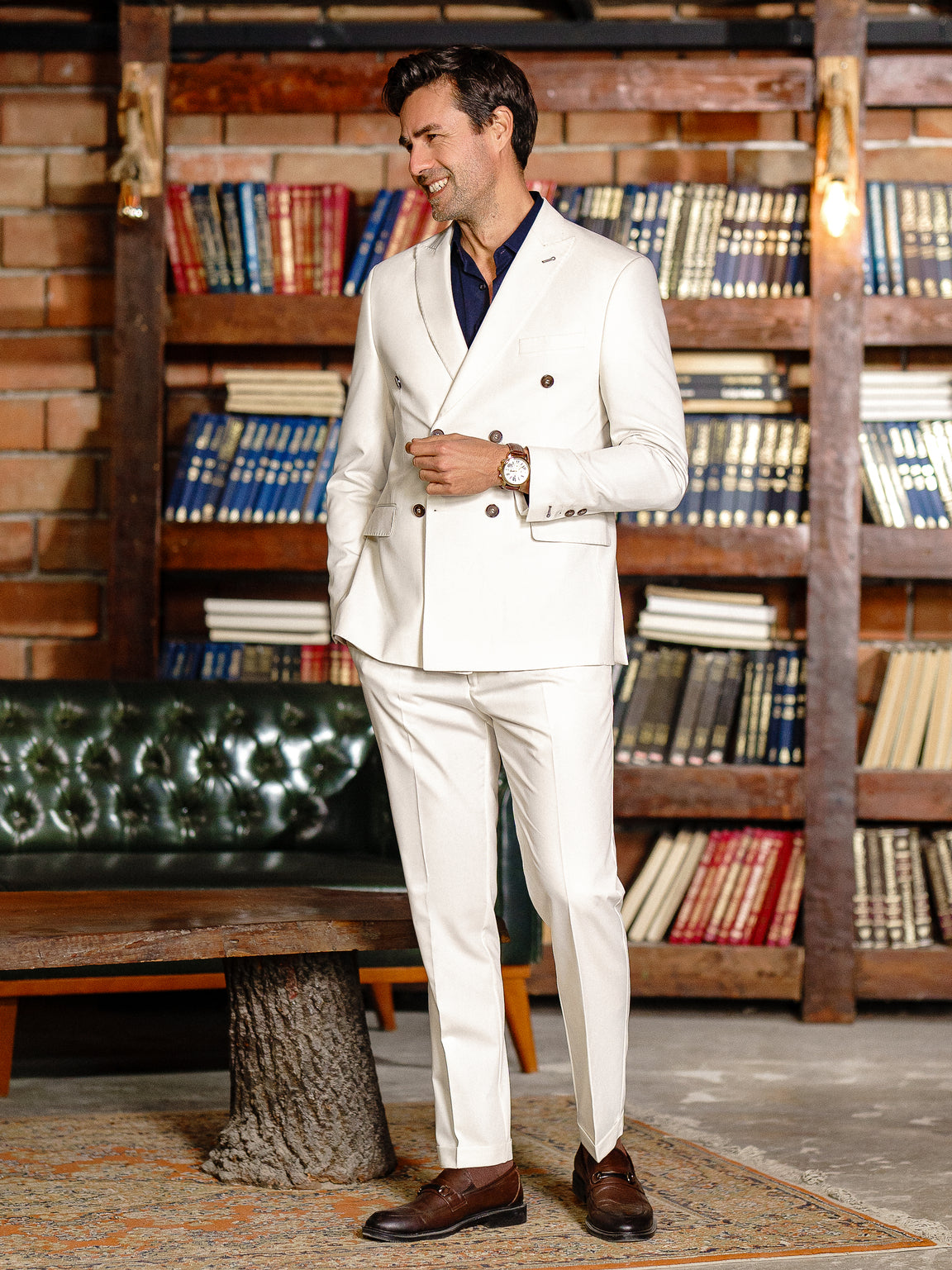Men’s white double-breasted slim-fit suit with tailored trousers, styled with a dress shirt and tie for a clean, modern formal look.