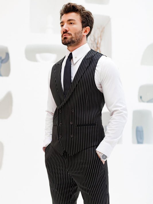 Men’s black pinstripe double-breasted vest with matching slim-fit trousers, styled with a white shirt and black tie for a modern formal look.
