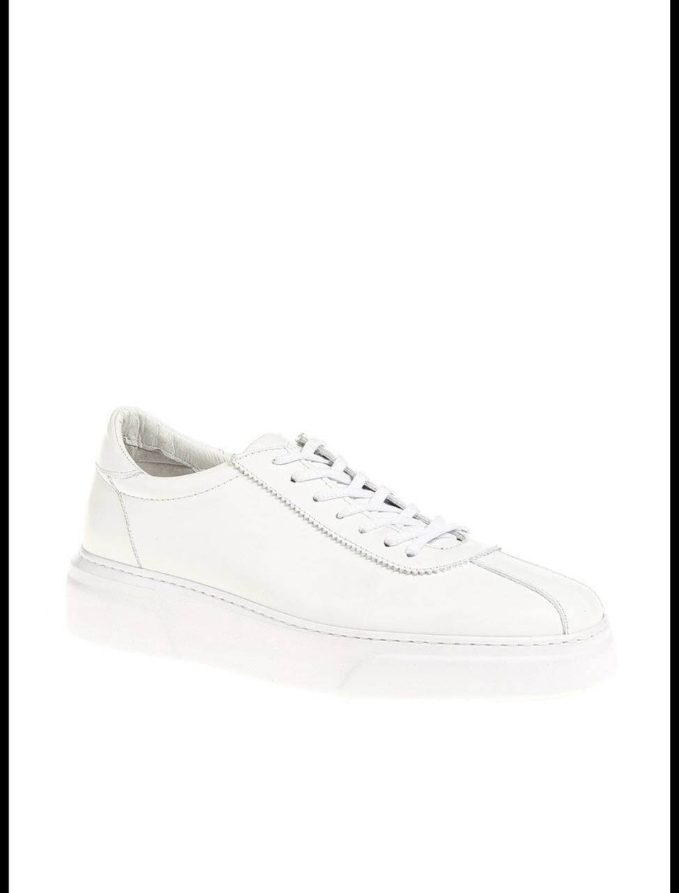 Sleek white leather low-top sneaker with clean stitching and minimal detailing. 