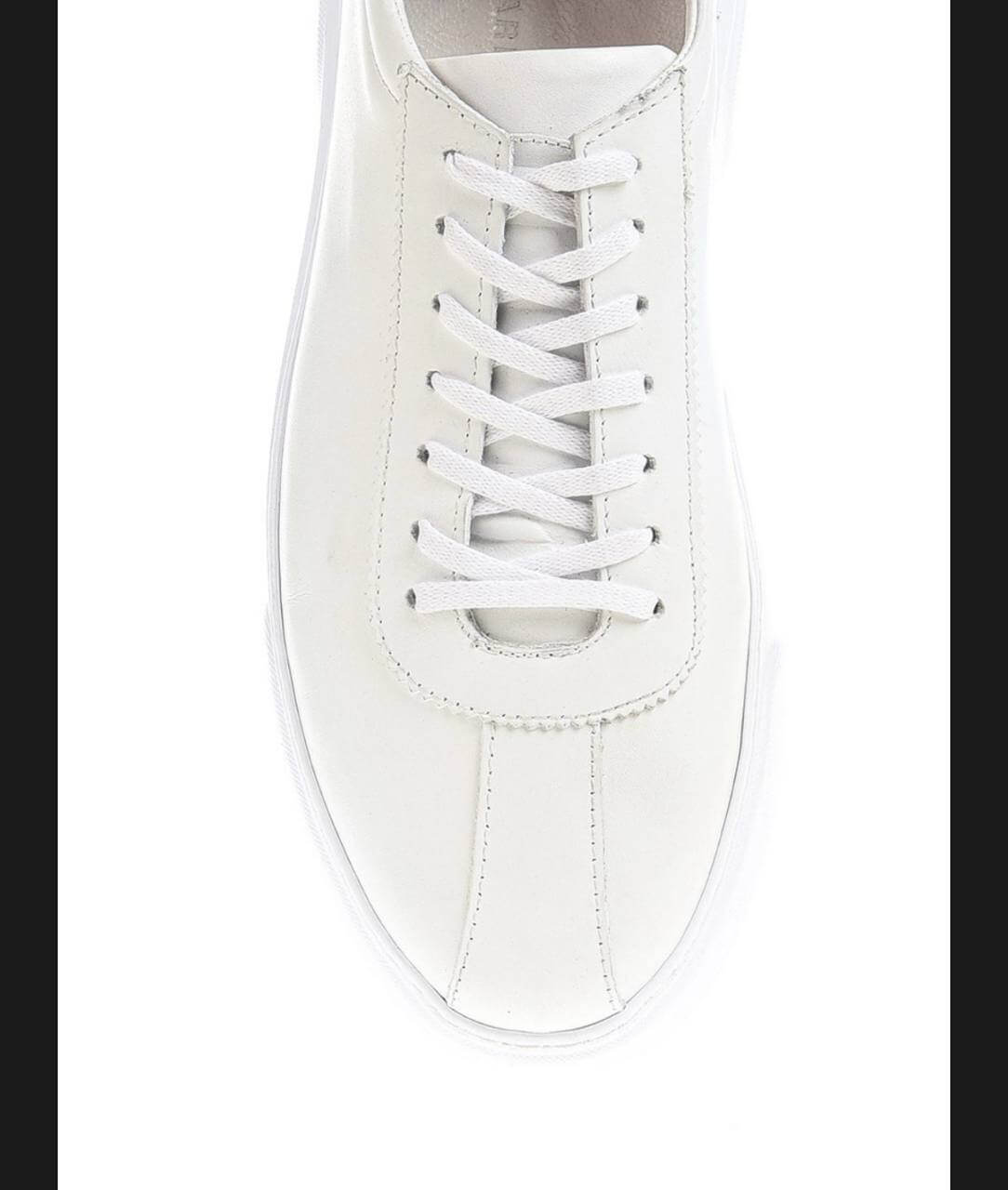 Sleek white leather low-top sneaker with clean stitching and minimal detailing. 