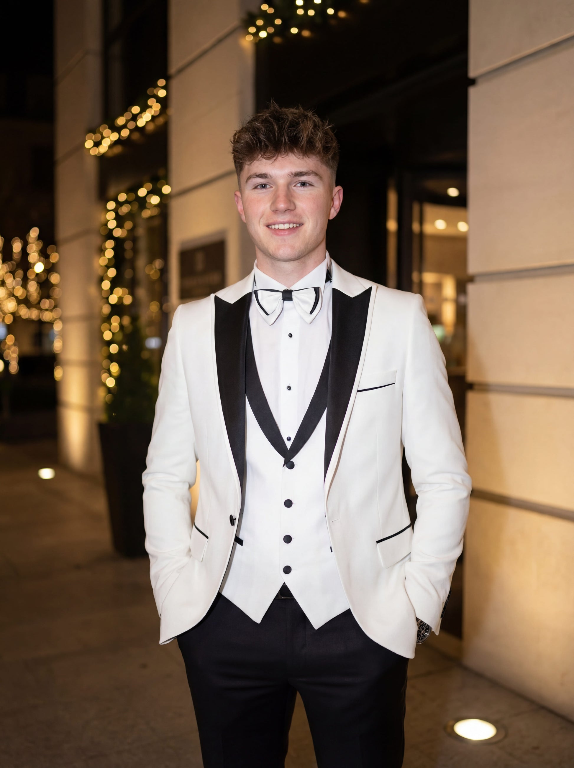 White slim fit prom tuxedo with black satin shawl lapel styled for formal prom event