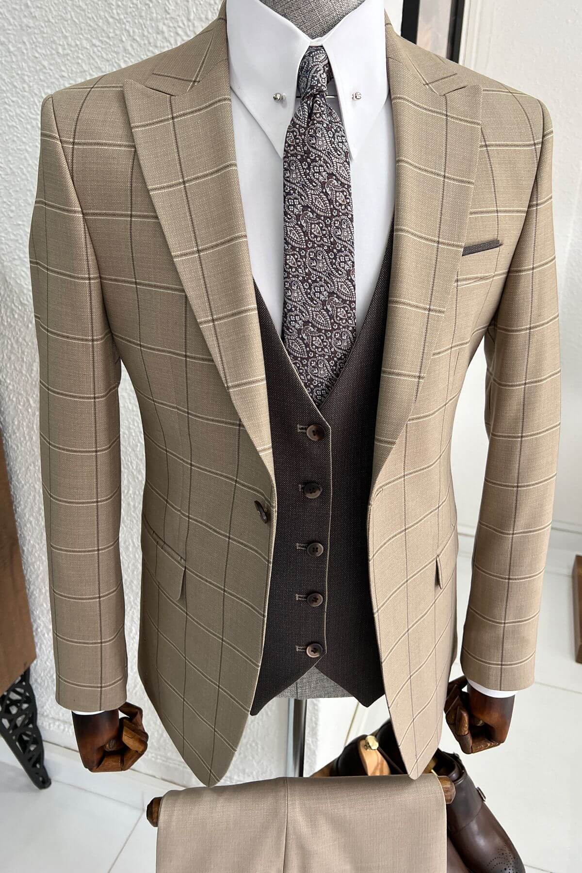 A Beige and Brown Wool Suit on display