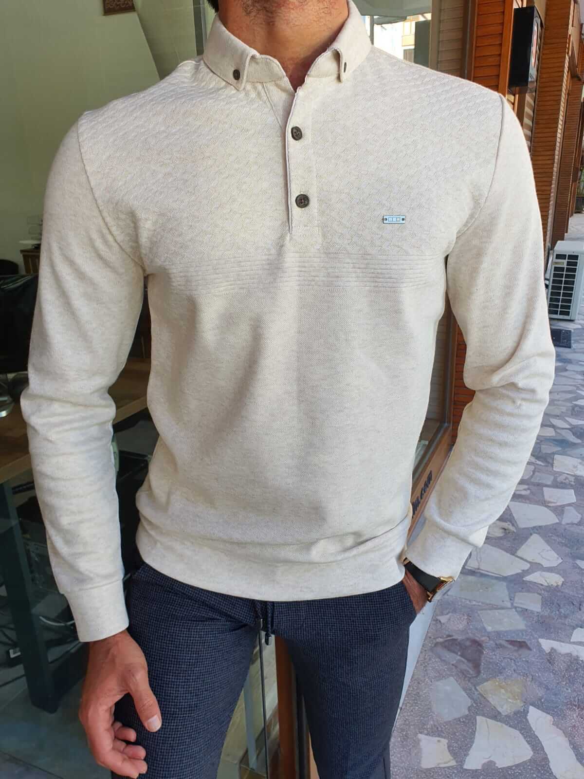 A beige longsleeve combed knitwear garment with a soft, textured surface.