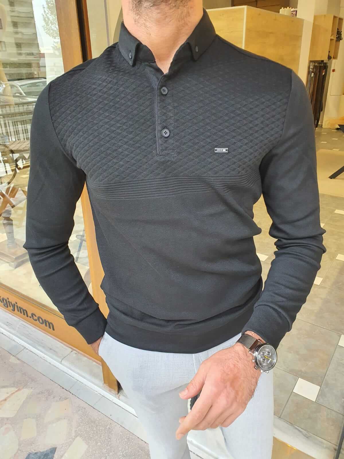 A black long sleeve combed knitwear, featuring a textured pattern and a cozy, comfortable fit.