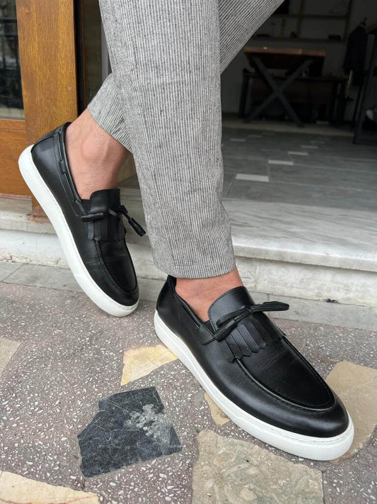 Black leather loafers with tassel detail and EVA sole, designed for comfortable casual wear during spring and summer.