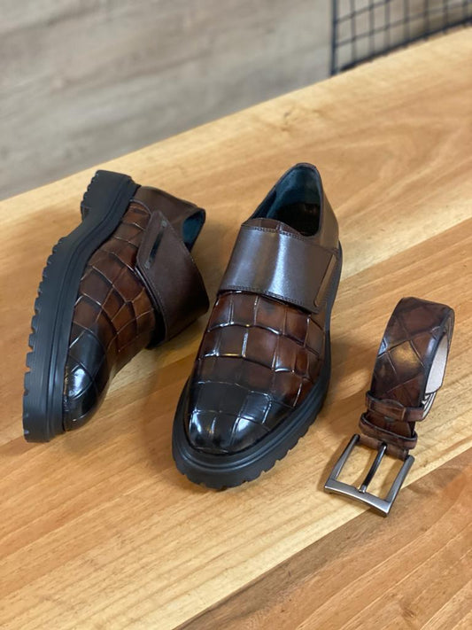 Premium brown calf leather monk strap shoe with buckle detail, showcased at an angle on a wooden surface, emphasizing its elegant design and durable EVA sole