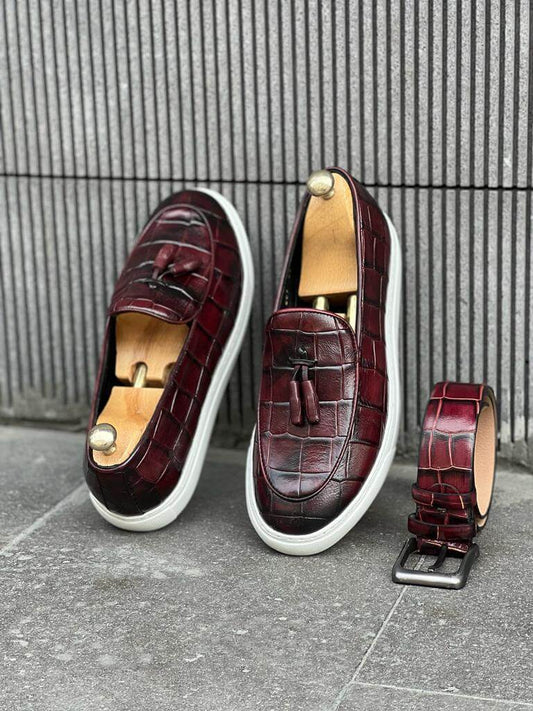 Burgundy leather slip-on loafers with tassel detail and a white EVA sole, offering a sleek and versatile style for warm seasons.