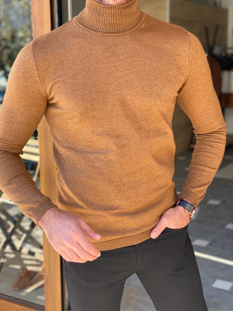 A stylish camel-colored turtleneck sweater, perfect for chilly weather in Cardiff. The sweater features a high neck and a cozy, knitted texture."