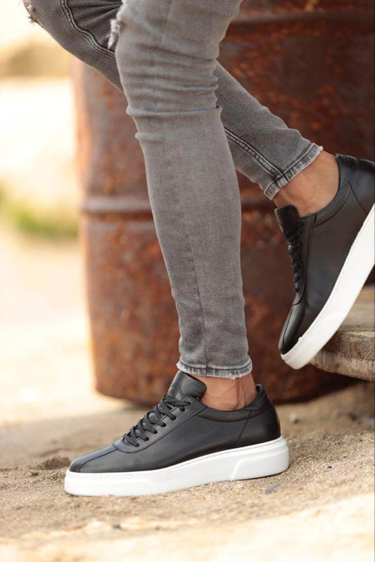 A pair of black leather sneakers featuring a white chunky EVA sole and lace-up design, styled for bold urban outfits and smart-casual versatility.