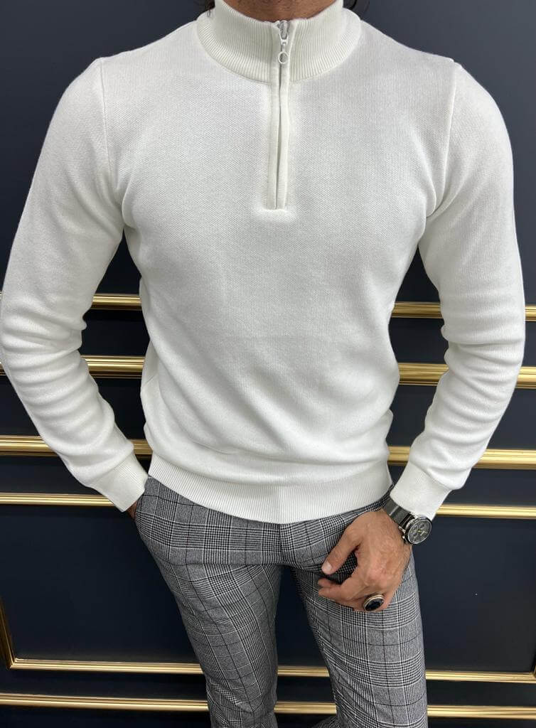 A combed white sweater, featuring a soft and textured knit pattern. The sweater has a relaxed fit and a cozy, ribbed collar.