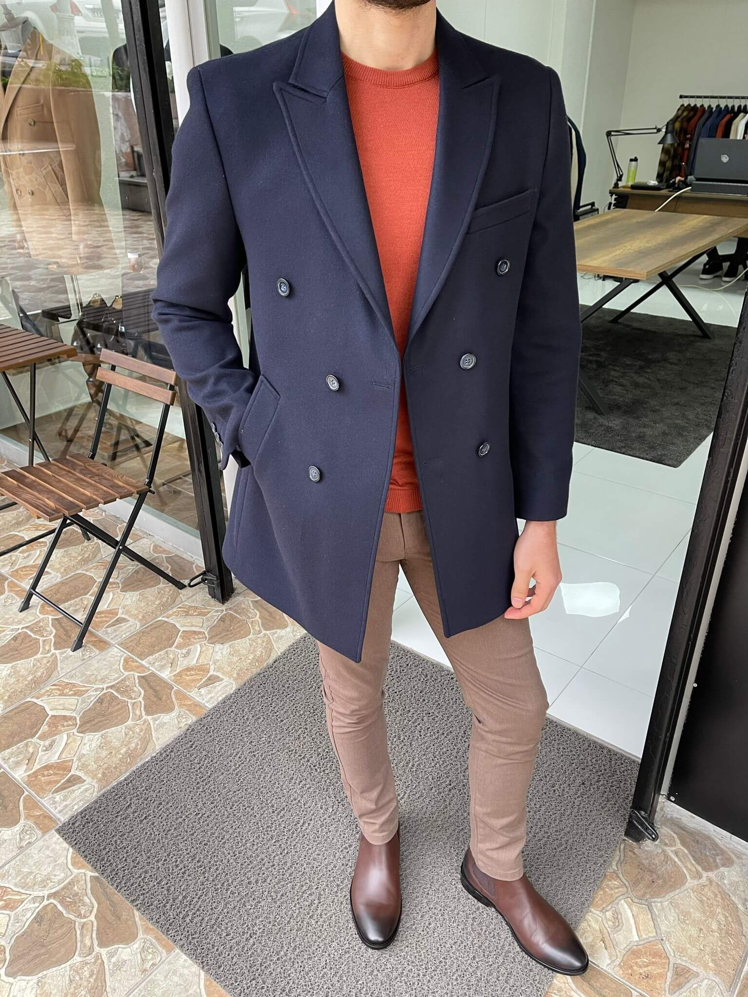 ouble-breasted navy blue wool coat, perfect for both casual and formal occasions