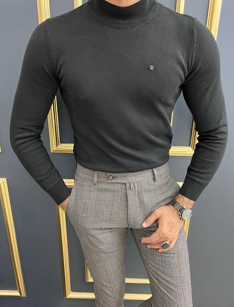 A black turtleneck sweater worn by Dunstan, featuring a stylish and minimalist design