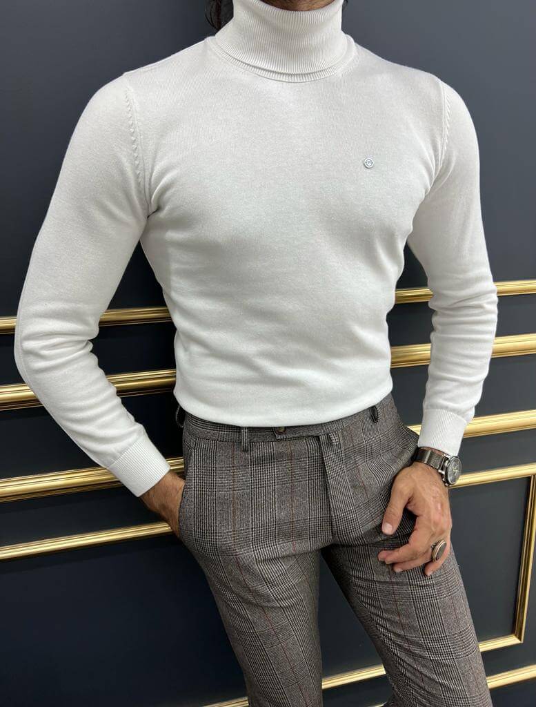 A close-up of Dunstan, a model wearing a stylish white turtleneck sweater, highlighting its textured fabric and modern design.