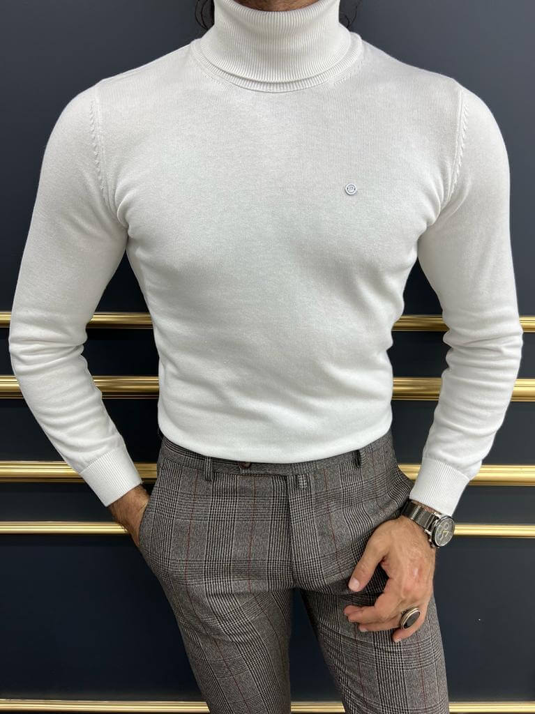A close-up of Dunstan, a model wearing a stylish white turtleneck sweater, highlighting its textured fabric and modern design.