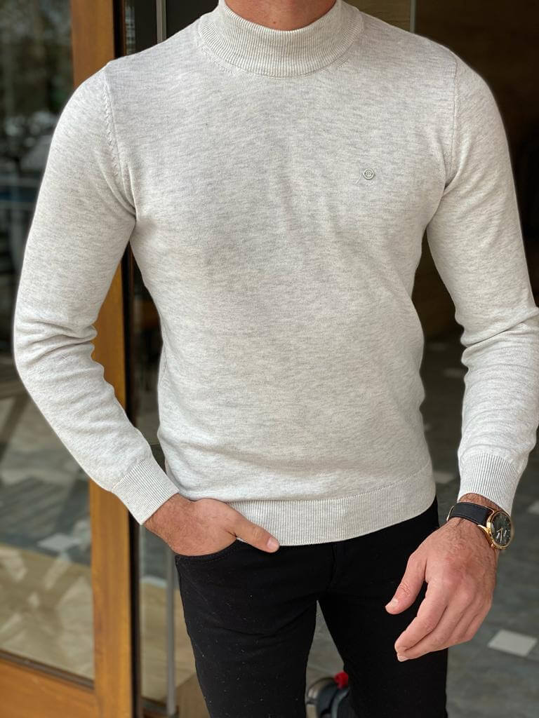 An elegant gray turtleneck sweater made of soft, knitted fabric, providing a cozy and stylish 