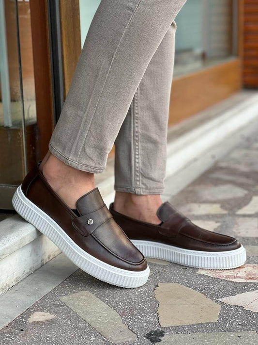 Rich brown leather penny loafers featuring a sleek silhouette and EVA sole, ideal for smart-casual and warm-weather styling.
