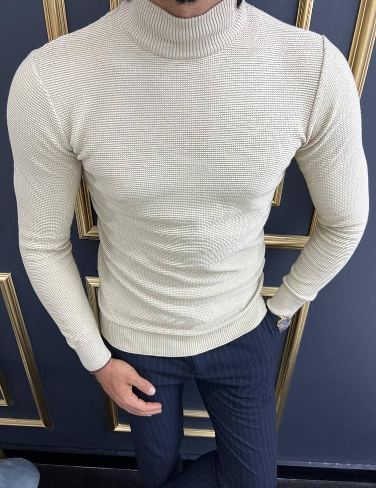 A close-up view of a beige mock turtleneck sweater worn by a model