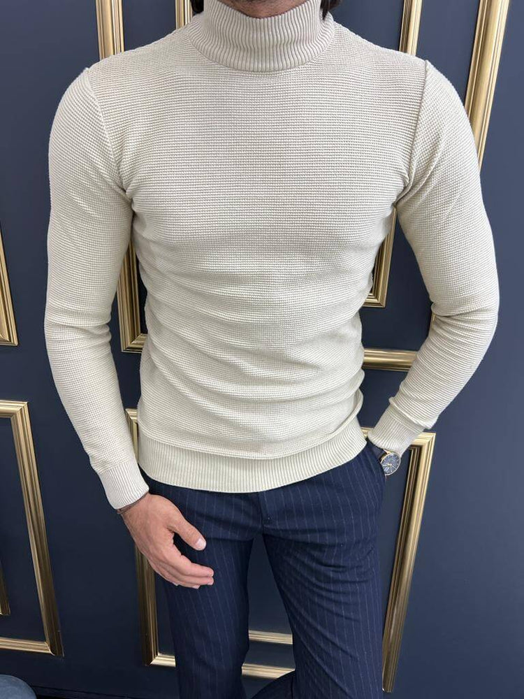 A close-up view of a beige mock turtleneck sweater worn by a model
