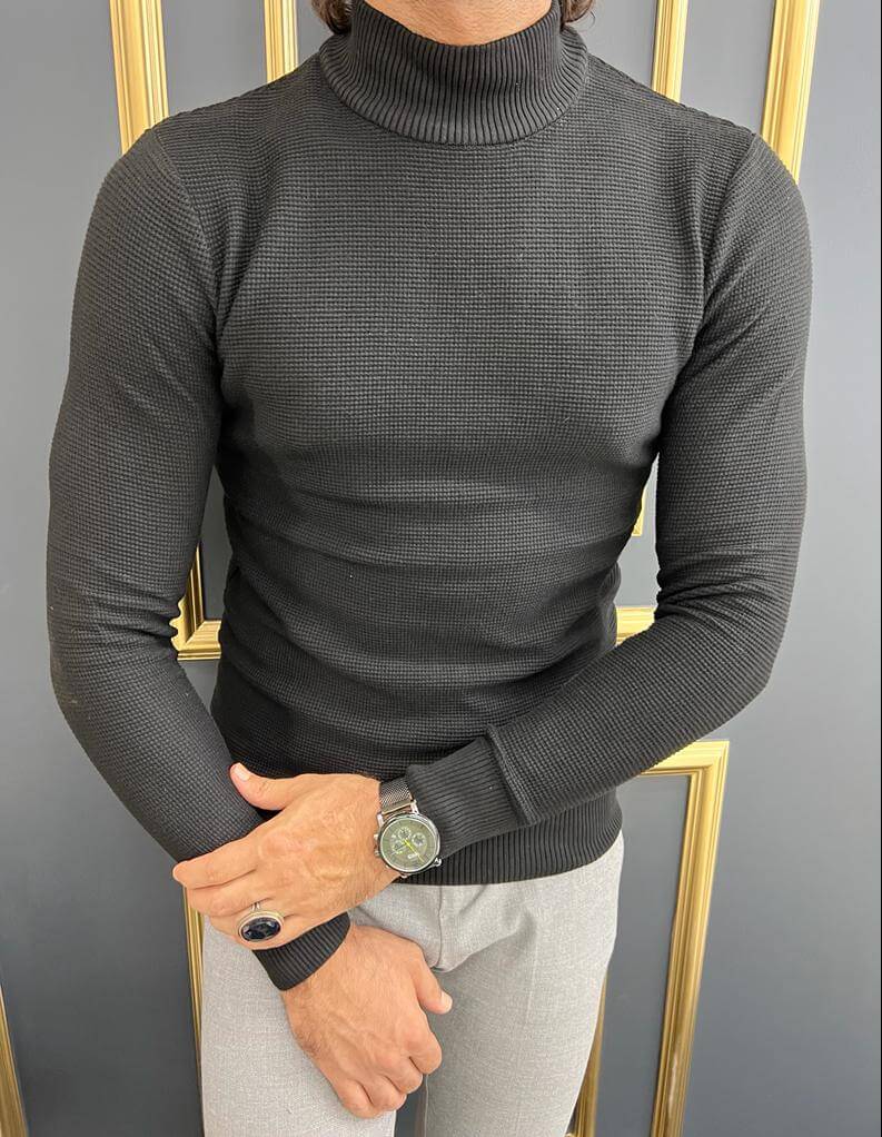 A black mock turtleneck with a smooth texture and a solid black color, making it a versatile and stylish addition to any outfit."