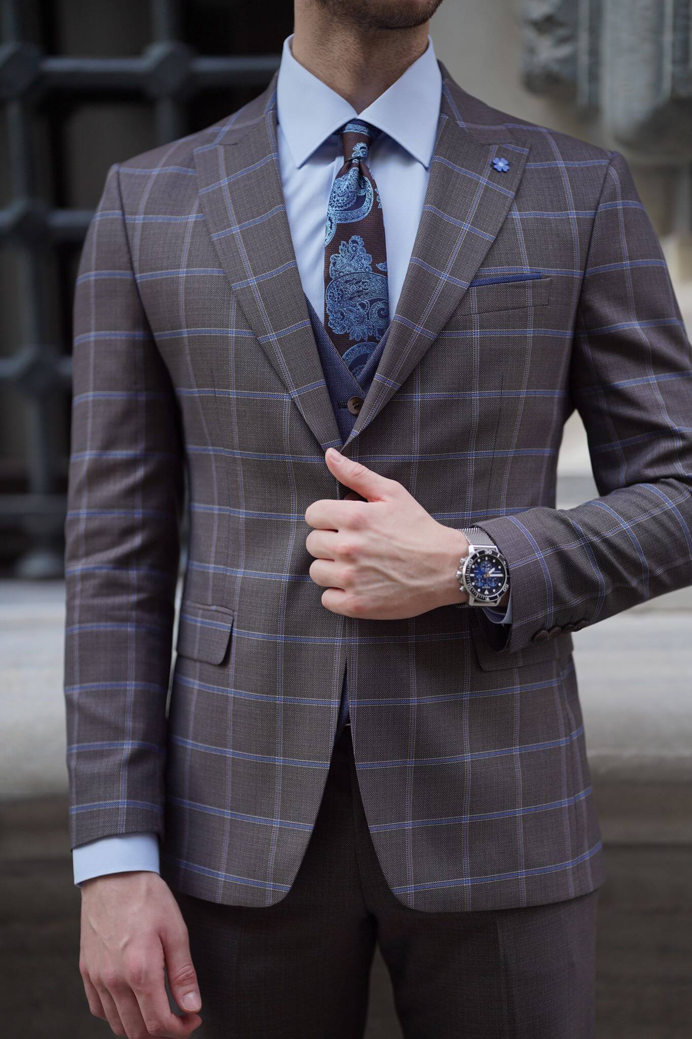 A Slim-Fit Plaid Brown Wool Combination Suit on display.
