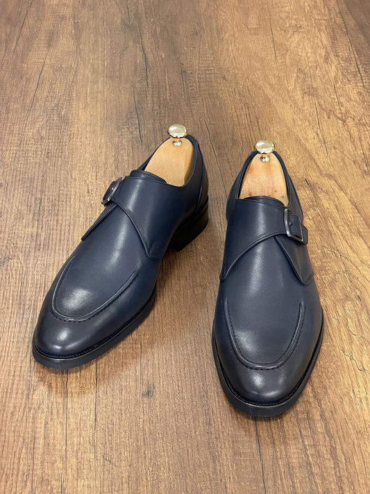 Classic navy blue leather single monk strap shoes with silver buckle detail, designed for versatile fall-winter styling and refined elegance.
