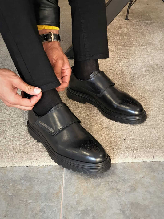 Elegant black monk strap leather shoes with double buckle detail, crafted from calf leather and rubber soles, styled for fall-winter menswear collections.