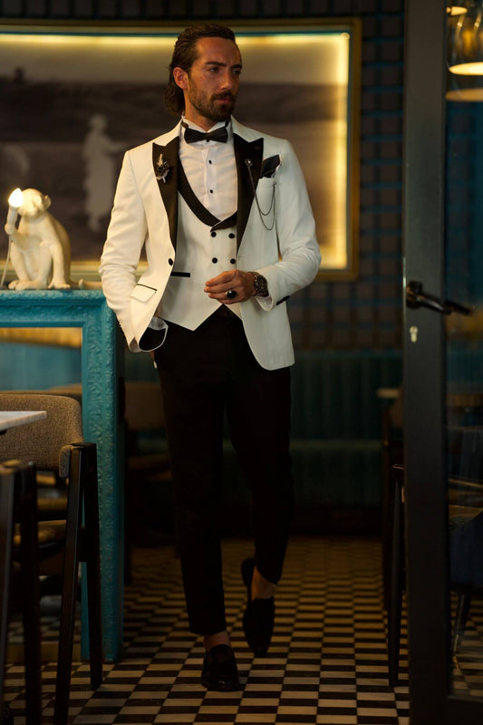 Slim-fit white tuxedo from HolloMen’s Spring Summer Collection, featuring a dovetail collar, double slits, single-button closure, and full formal set including jacket, vest, pants, shirt, and bow tie – ideal for weddings and upscale events.