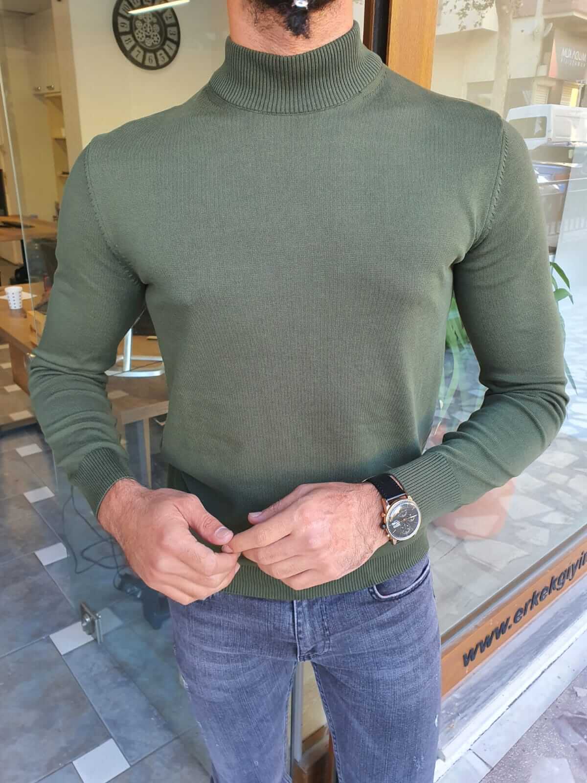 A vibrant Hunza Green Turtleneck sweater made of soft, ribbed fabric. The turtleneck features a snug fit and long sleeves, providing warmth and style.