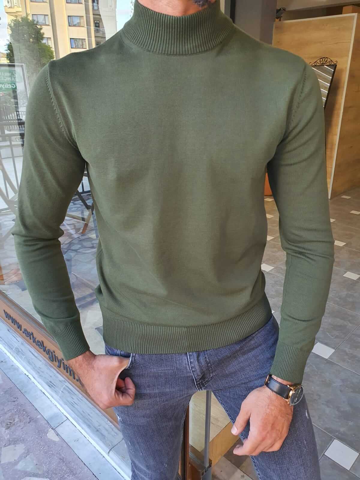 A vibrant Hunza Green Turtleneck sweater made of soft, ribbed fabric. The turtleneck features a snug fit and long sleeves, providing warmth and style.