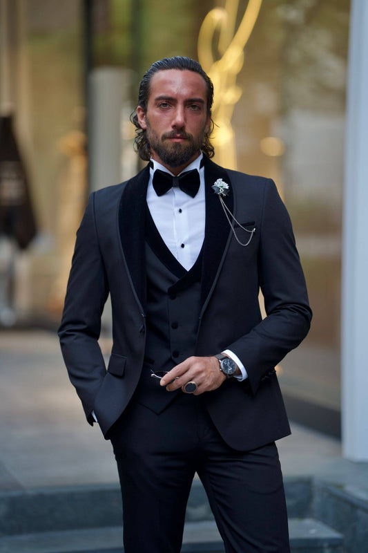 Slim Fit Black Tuxedo from HolloMen’s Spring Summer Collection featuring a shawl collar, double slits, single button, and full formal package with vest, pants, shirt, bowtie, chain, and flower pin – perfect for weddings and black-tie events.
