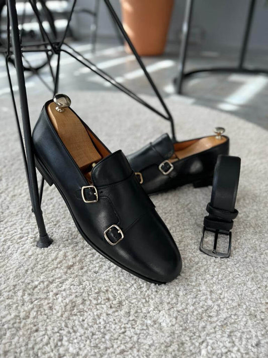 Elegant black leather double buckle monk strap shoes with a sleek finish and neolite sole, styled for modern formal wear and seasonal versatility.