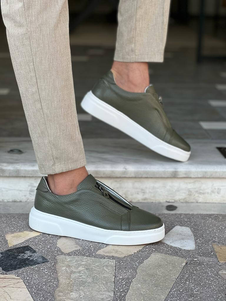 Khaki leather sneakers featuring a side zipper and minimalist laces, set on a lightweight EVA sole, styled in natural lighting against a neutral background.