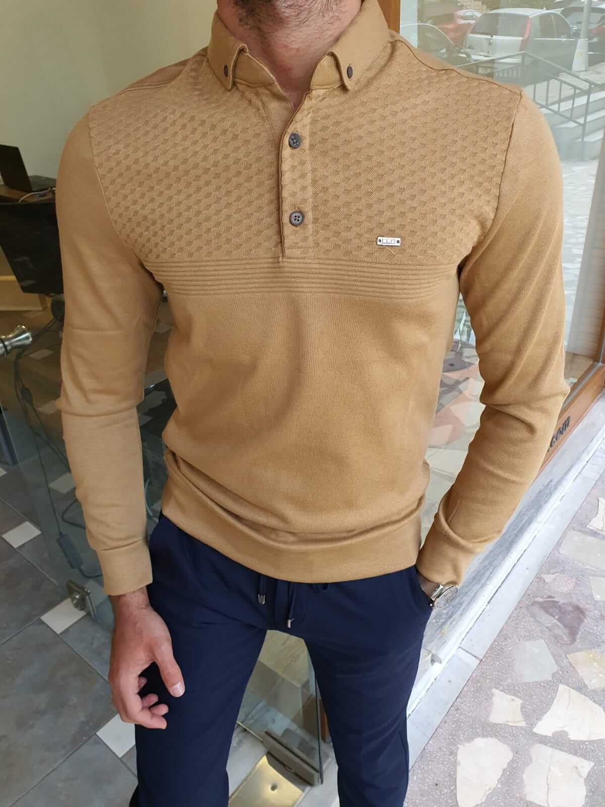 A mustard-colored longsleeve combed knitwear. The knit fabric has a soft texture and features a ribbed pattern. 