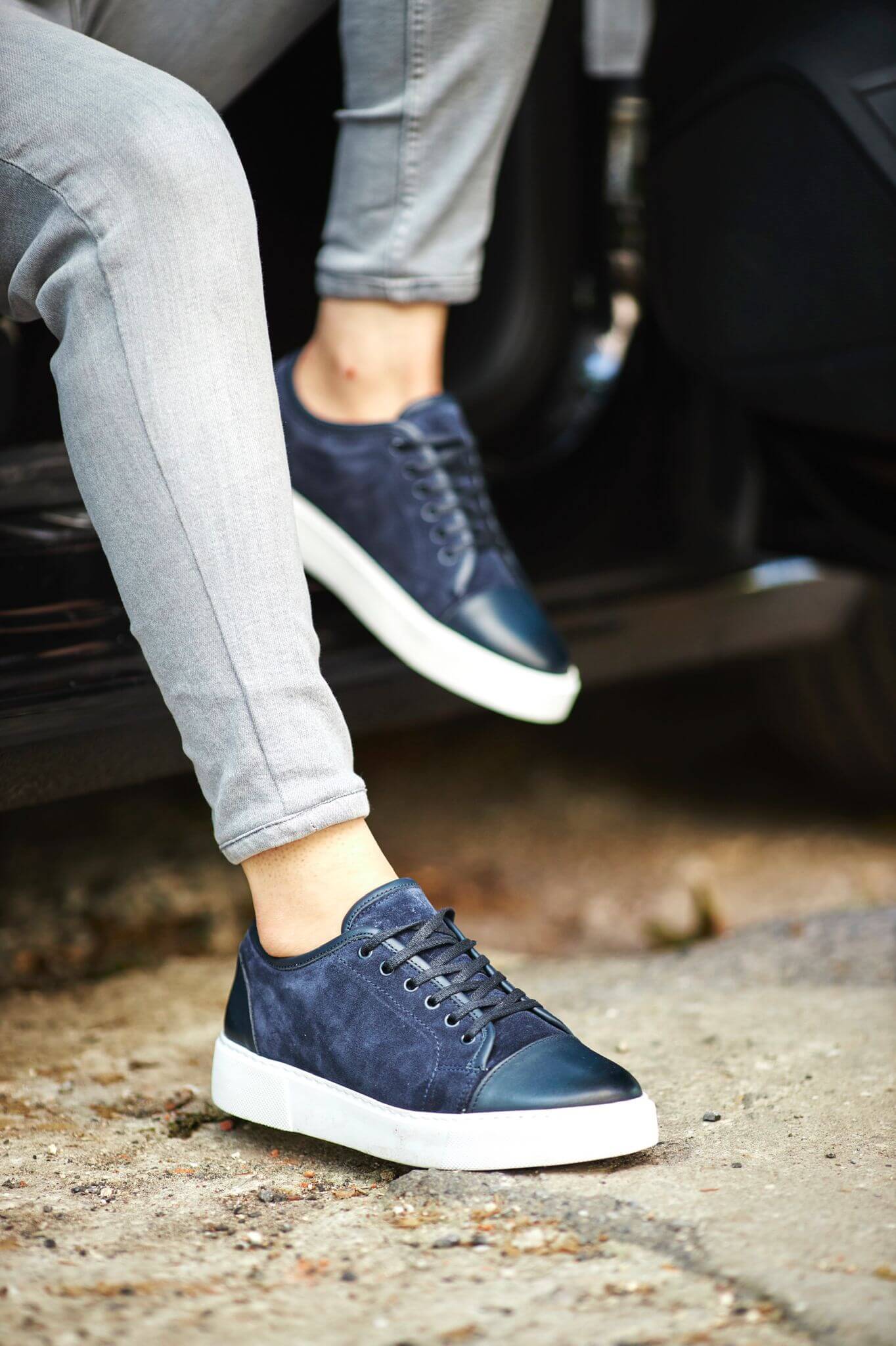 A Navy Blue Lace up Sneaker on display.