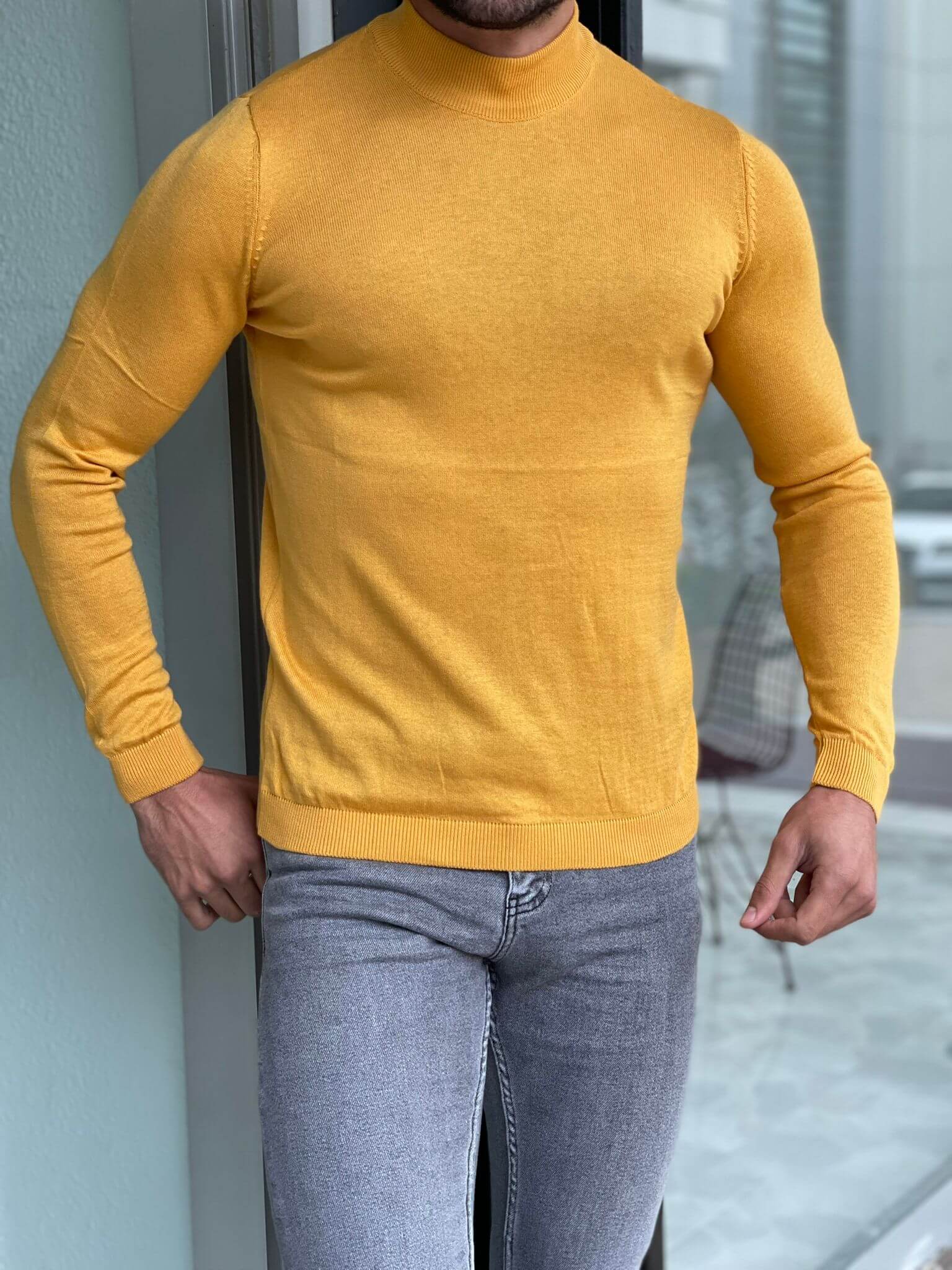 "An Osaka Mustard Half Turtleneck sweater, featuring a warm mustard color, a cozy half turtleneck collar, and a stylish design perfect for cooler weather."