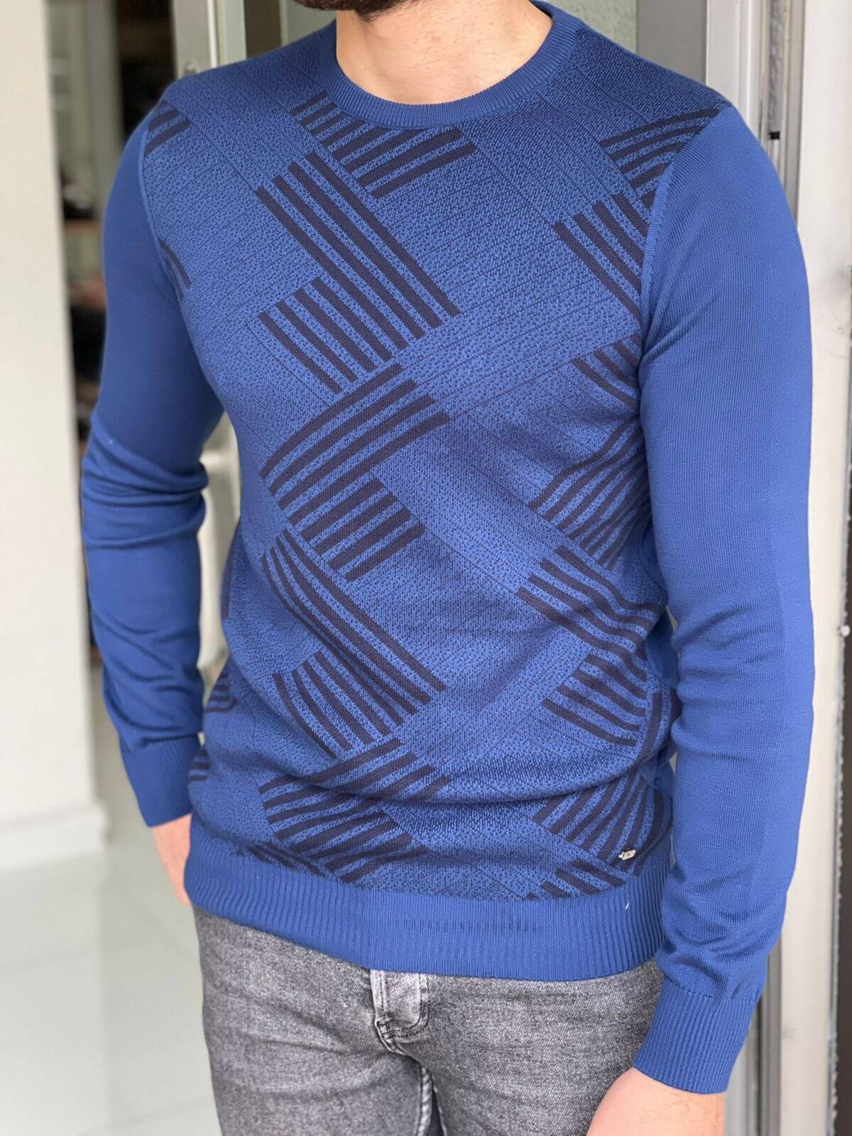 A crewneck sweater with a saxophone pattern. The sweater features a unique design with vibrant colors and intricate saxophone illustrations.