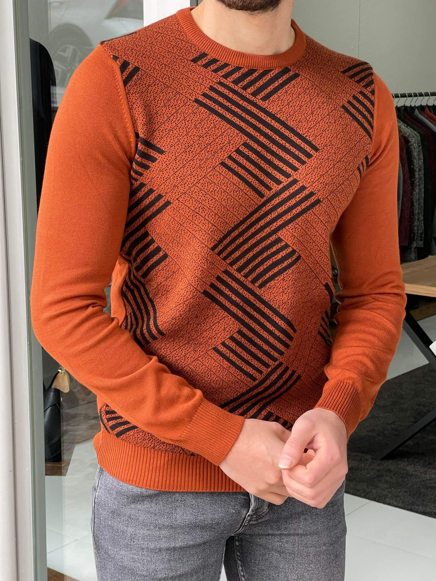 A crewneck sweater with a striking patterned tile design, combining vibrant colors and geometric shapes."