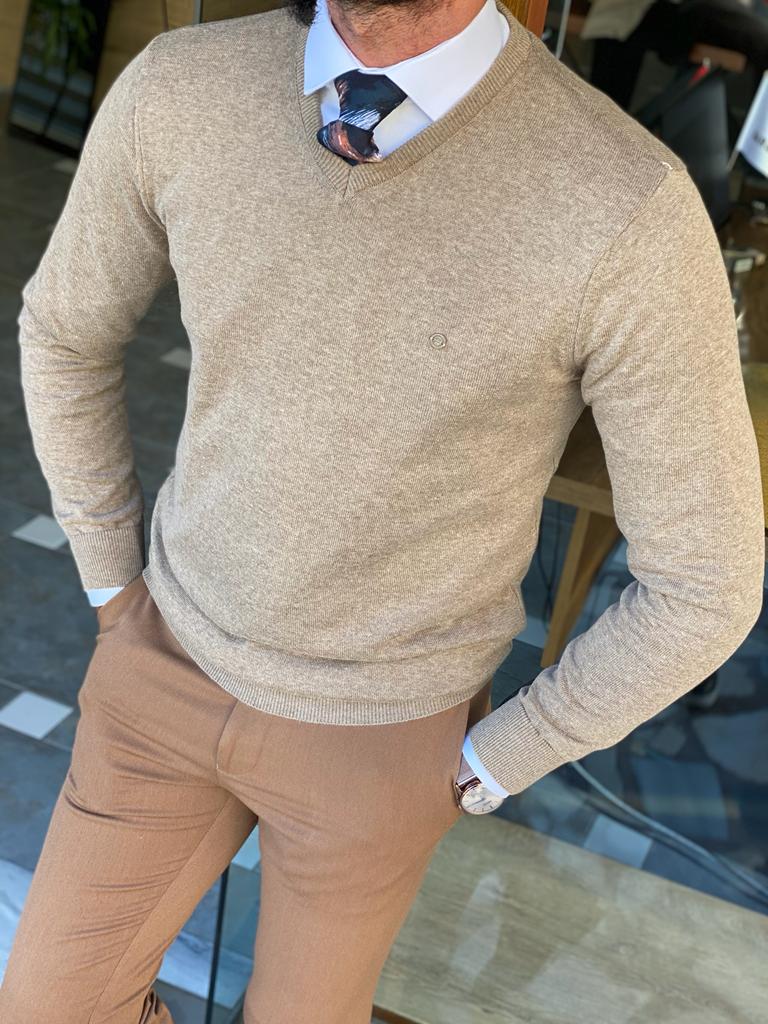 A slim fit beige knitwear sweater with a textured pattern. The sweater features a round neckline and long sleeves, providing a stylish and comfortable option for a casual or semi-formal look.