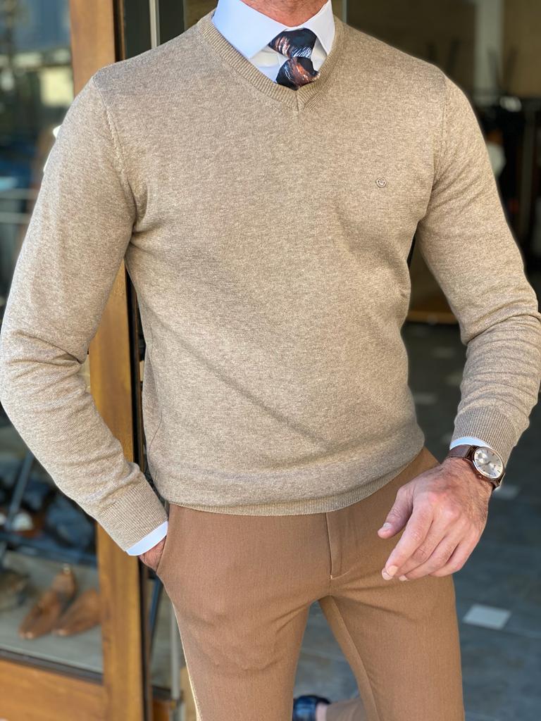 A slim fit beige knitwear sweater with a textured pattern. The sweater features a round neckline and long sleeves, providing a stylish and comfortable option for a casual or semi-formal look.